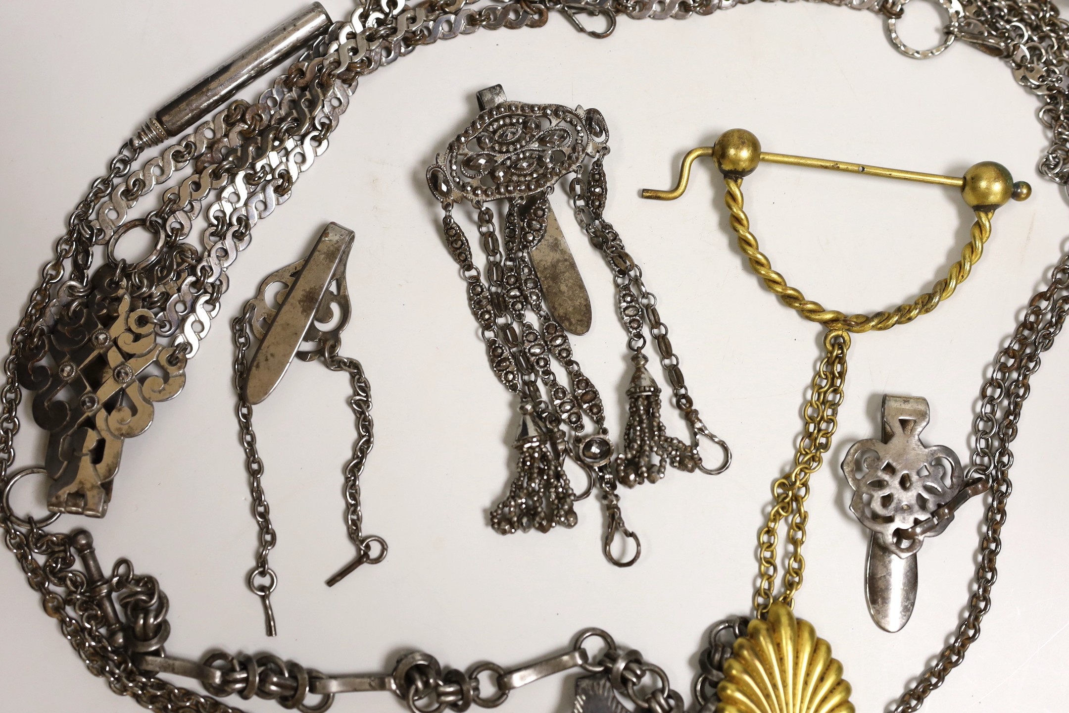 A 19th century cut steel Chatelaine, three others, a similar clasp and a later gilt metal Chatelaine and a cut steel Albert, (7)